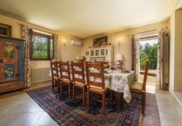 The dining room with access to the external dining area and internal stairs – Podere Santa Croce