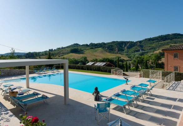 The pool area is decorated with bronze sculptures – Podere Terranuova