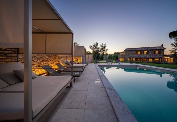 The pool and main house at night - Poggio Ambrato