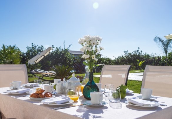 Nei pressi della piscina, uno spazio riservato all’uscita dalla villa accoglie un'area pranzo - Profumo di Zagara