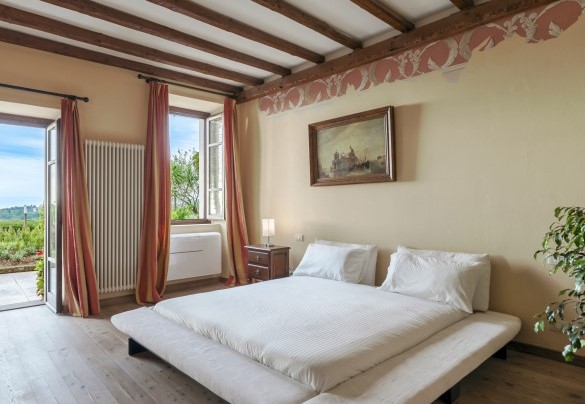 A french door in the bedroom n.1 leads to the paved outdoor terrace – Tenuta Navelli