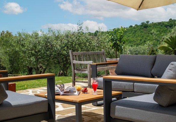  Outdoor lounge shaded by an umbrella - Tenuta Santa Cristina