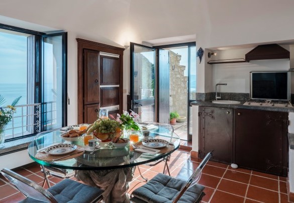 The entrance door leads into an open space with a small living area, dining table and kitchenette - Torre Grimaldi