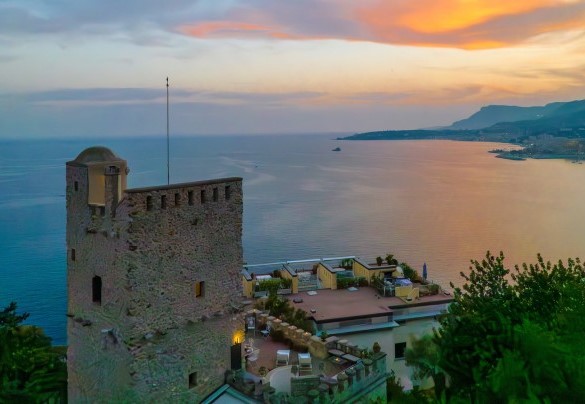 An enchanting sunset over the sea and the beautiful village of Menton, the starting point of the renowned French Riviera (Cote d'Azur) - Torre Grimaldi