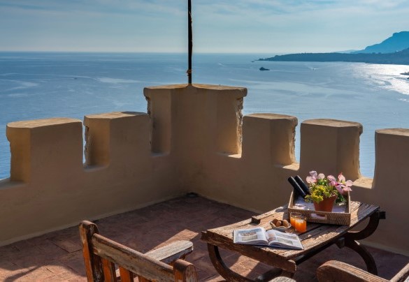 A last flight of spiral stairs leads to the panoramic terrace on the roof of the tower equipped with a sitting area and sun loungers - Villa Grimaldi
