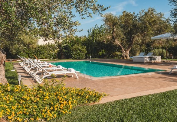 The large stoneware solarium that perimeters the pool at every angle -Trulli Biancapetra