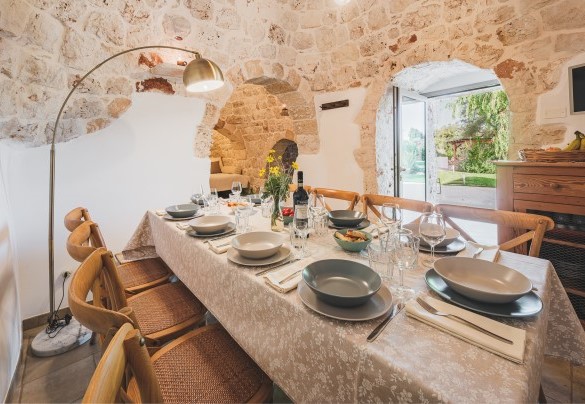 The table set up for lunch connected to the main entrance -Trulli Biancapetra