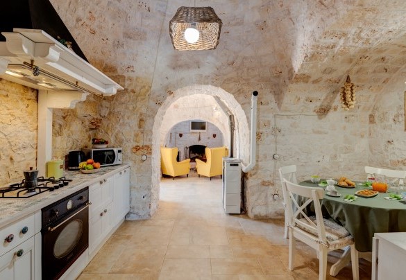 The well-equipped kitchen of Trulli Littoria has a lovely dining area – Trulli Littoria