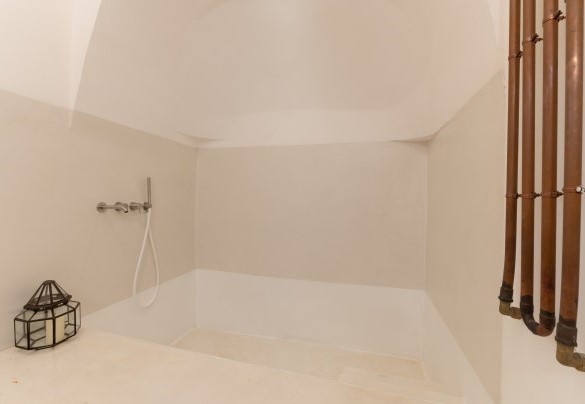 Il bagno en-suite alla camera matrimoniale n.2 nei trulli, dispone di una caratteristica vasca in pietra cui si accede attraverso tre gradoni - Trulli Santa Pazienza