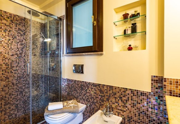 Il bagno con mattonelle a mosaico e doccia - Villa Alba