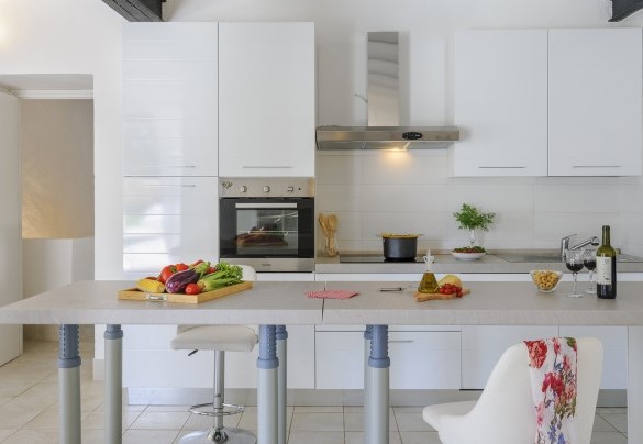 The kitchen positioned in a corner of the large dining area – Villa Ardente