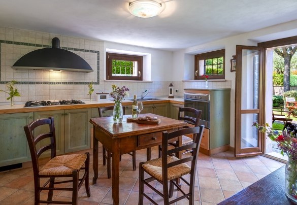 La cucina al piano terra è comodamente collegata al giardino tramite una porta finestra – Villa Banci