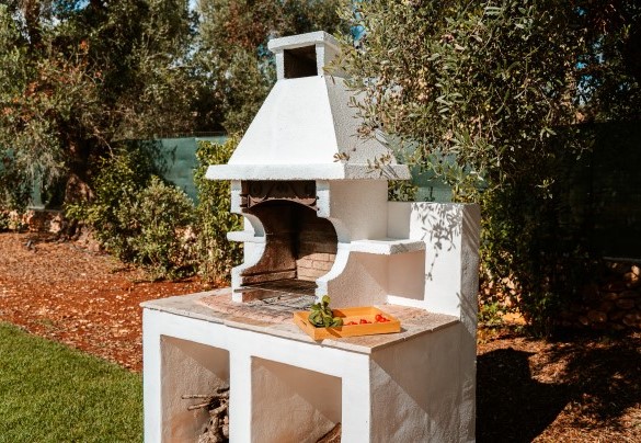 The spacious patio by the pool is complemented by a practical brick barbecue surrounded by a herb garden - Villa Belkis