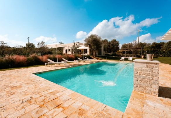 The pool measures 12 x 5 m and a large waterfall embellishes the blue water basin - Villa Belkis