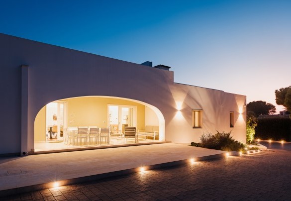 The porch lit in the evening on the west side -Villa Bellina