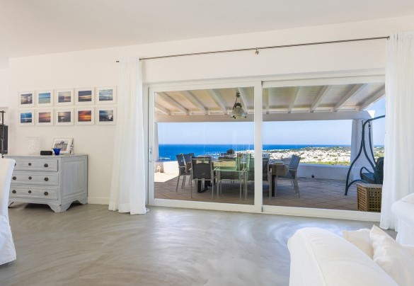 From the living area a large window leads to the external dining area - Villa Calypso