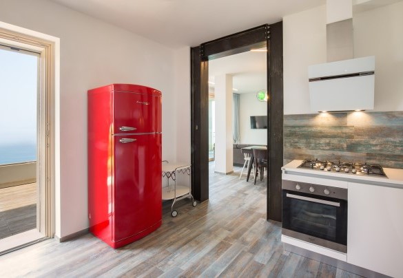 The ground-floor kitchen has a large red fridge - Villa Claudia