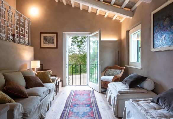 Area soggiorno del primo piano con divano e due pouf letto singolo per due posti letto aggiuntivi – Villa Dianella