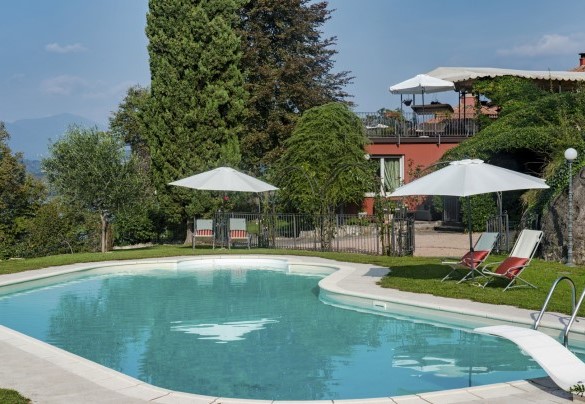 The solarium is covered with a grassy surface and equipped with sunbeds, deckchairs and umbrellas - Villa Eden