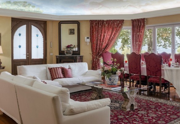 The elegant lounge with large windows overlooking the lush park – Villa Eden