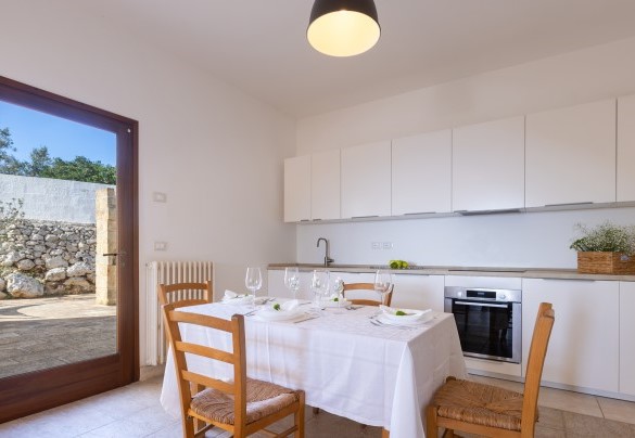 Cucina e zona pranzo, con accesso al patio che conduce alla zona solarium e al barbecue - Villa Floria