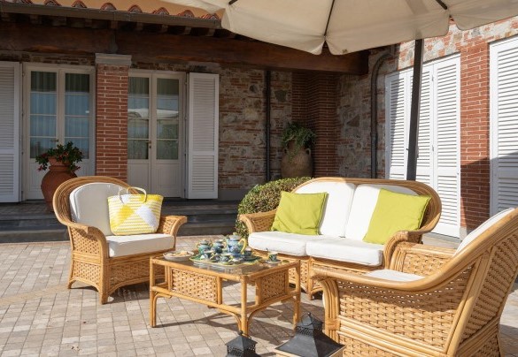 The outside sitting area shaded by a large umbrella - Villa Gabri