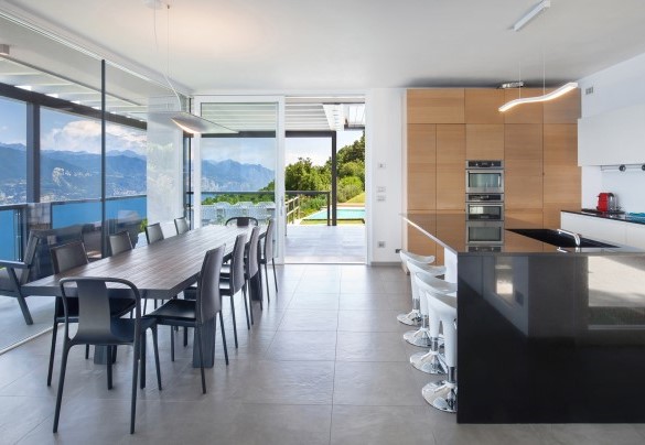 La grande cucina abitabile con isola centrale e tavolo da pranzo vista lago - Villa Gemmma