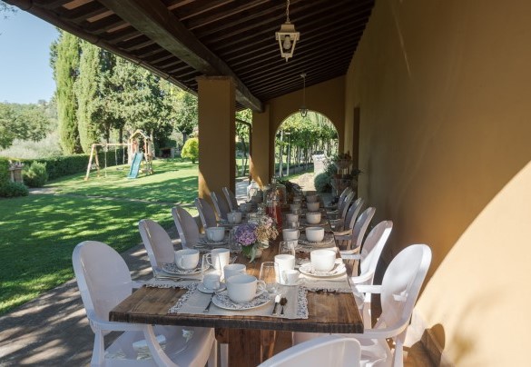 The porch shades the table prepared for outdoor breakfast – Villa Ginestraio