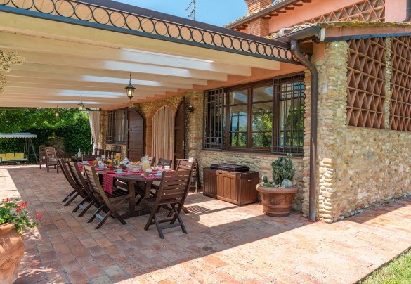 The porch shades the table prepared for outdoor breakfast – Villa Gino 