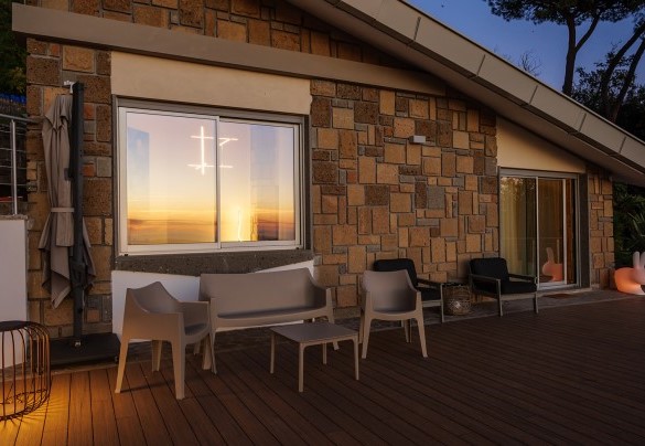 The terrace accessible from the living area, enveloped in the warm light of the sunset – Villa Giulia