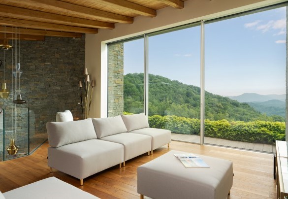 Gli arredi lineari e moderni si fondono in un tutt'uno con la pietra e il legno - Villa Krisztina