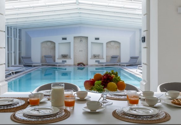 Veranda con porte vetrate e attrezzata a zona pranzo, area relax, collegata al tunnel di copertura della piscina, a diventare uno spazio chiuso e godibile anche in inverno - Villa La Perla Bianca 