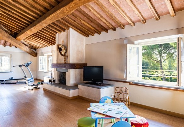 The living area with fitness corner and children's play area at the second floor – Villa Luigina