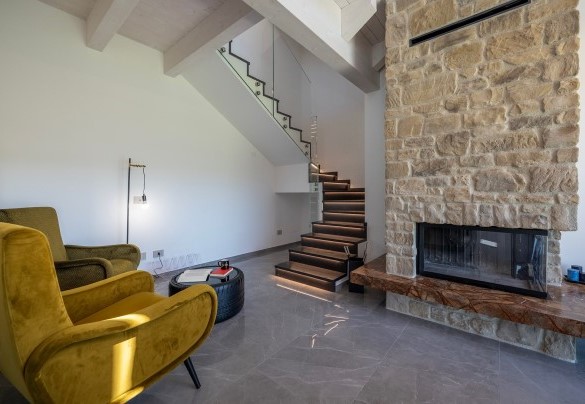 The ornamental fireplace and stairs to the first floor – Villa Mamon