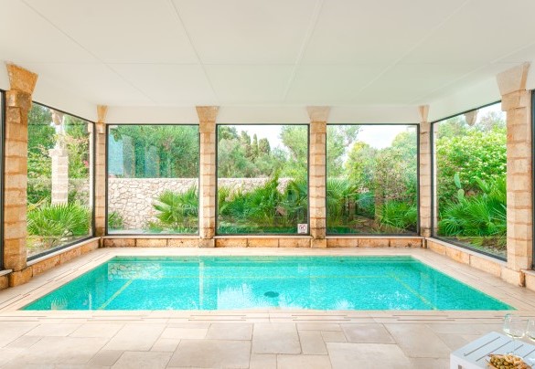 The charming indoor pool is surrounded by large windows   - Villa Manco
