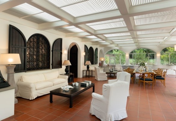 The large veranda set up with living and dining areas, grand piano and study corner - Villa Manganelli