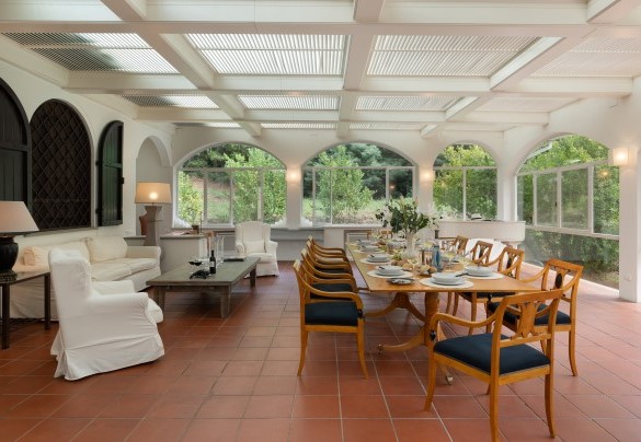 The large veranda set up with living and dining areas, grand piano and study corner - Villa Manganelli