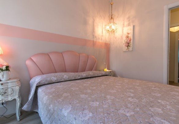 The charming master bedroom on the upper floor overlooks the garden - Villa Ombrosa
