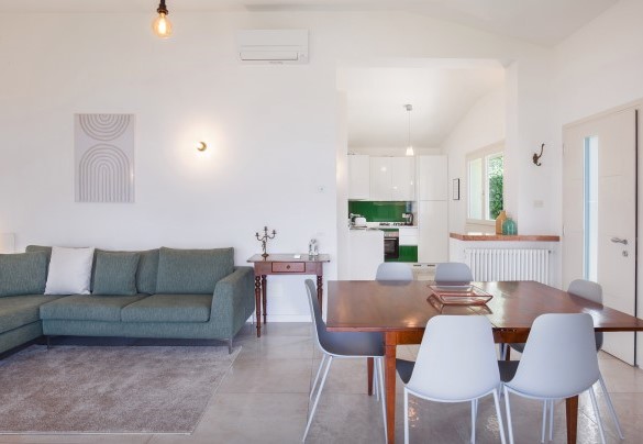 Open space with relax area and dining table - Villa Palladini