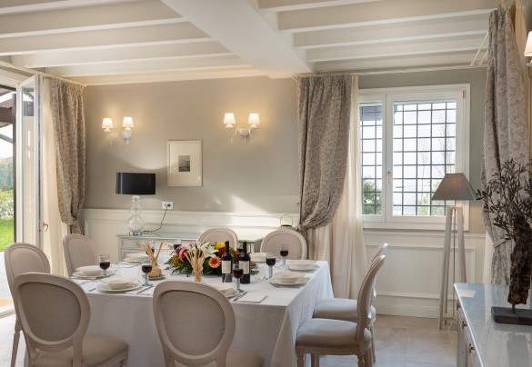 The dining area with an elegant square table continues towards the fully-equipped kitchen – Villa Pergola 8