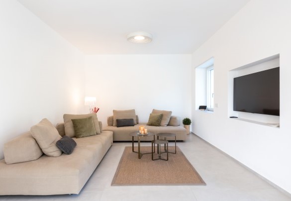The welcoming living area with sofas, smart TV, relaxation corner and direct access to the outside - Villa Petrillo