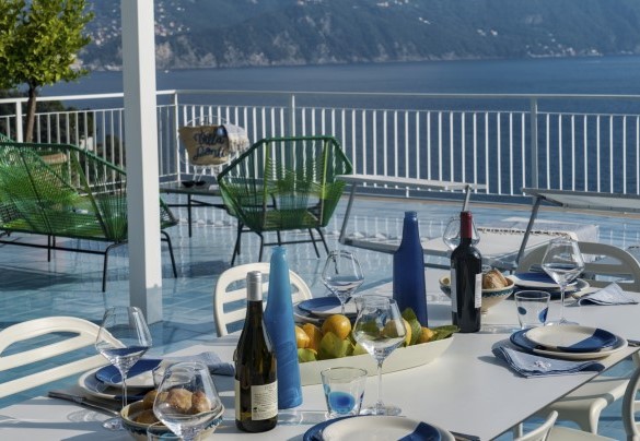 The large terrace, illuminated with floor spotlights, is furnished with table and chairs, outdoor sitting area, sun loungers and barbecue - Villa Ponti