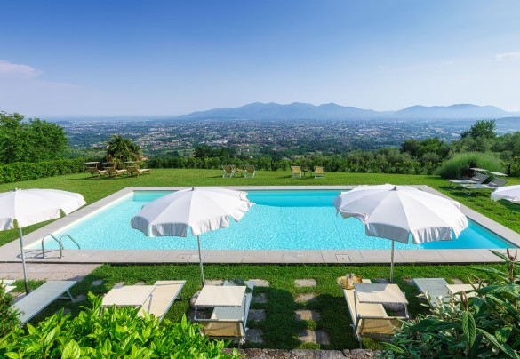 La piscina e la zona prendisole attrezzata con lettini, sdraio, sedie regista, ombrelloni e doccia solare - Villa Primo Sole 