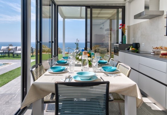 The kitchen with large sliding glass doors overlooking the porch and the swimming pool - Villa Sabbie Rosse