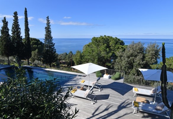 The infinity pool is set in a large wooden platform from where you can enjoy the wonderful view of the sea through the trees – Villa Armonia