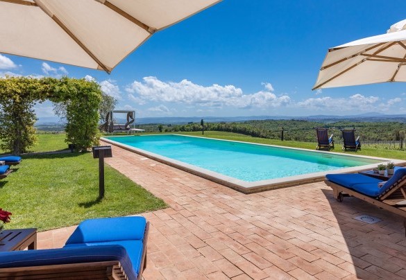 La piscina è adagiata in un’area sul retro del casale che regala uno scenario di particolare fascino su quinte di vitigni che cingono la proprietà - Villa Siena