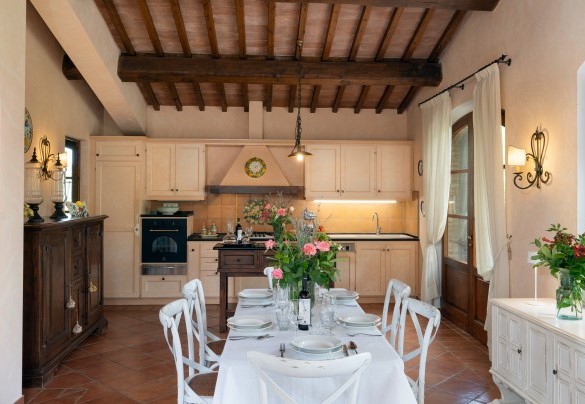 Open space con salotto con camino, area pranzo e cucina attrezzata al piano terra - Villa Sorripa