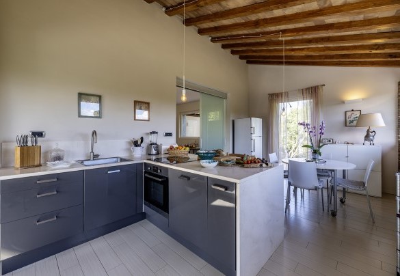 The well-equipped kitchen connects to the dining room, with a service exit - Villa Sparta