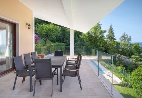 The covered terrace furnished with table and chairs outside the kitchens french window - Villa Sybille