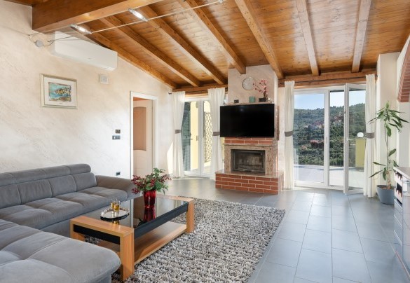 Il grande e luminoso soggiorno con il divano letto e il camino in muratura - Villa Vittorio